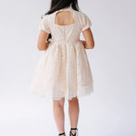 White lace mini dress with puff sleeves and a knee-length tulle skirt.