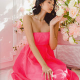 Woman in a pink strapless dress among cherry blossoms, featuring Watermelon Sugar Ambrosia