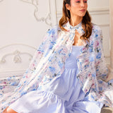 Floral print Wild Bloom Priestess Cape over a light blue dress for a chic look