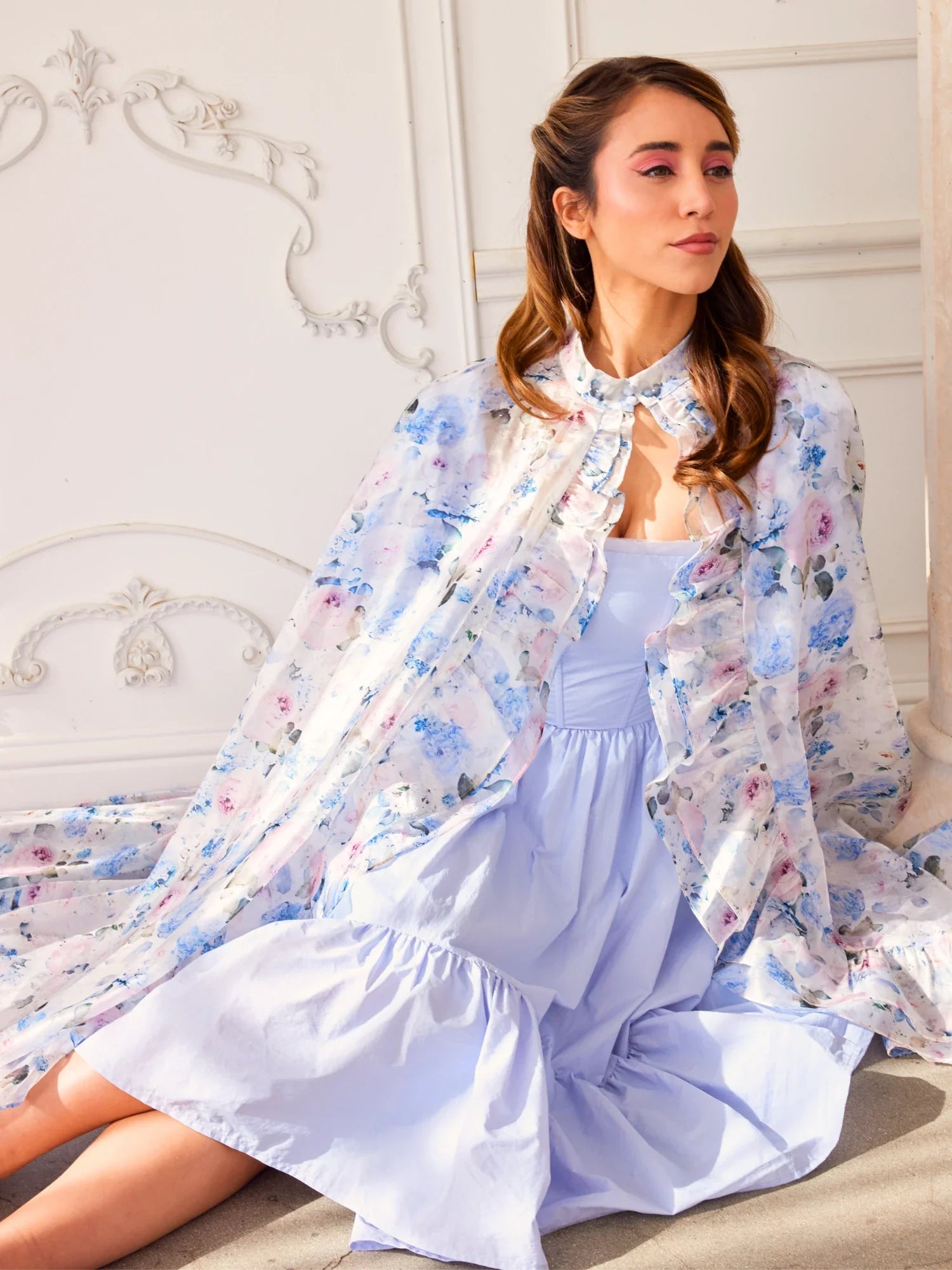 Floral print Wild Bloom Priestess Cape over a light blue dress for a chic look