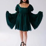 A woman wearing the woodland bell sleeve dress on a white background.
