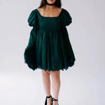 Front view of a woman wearing the woodland bell sleeve dress against a white background.