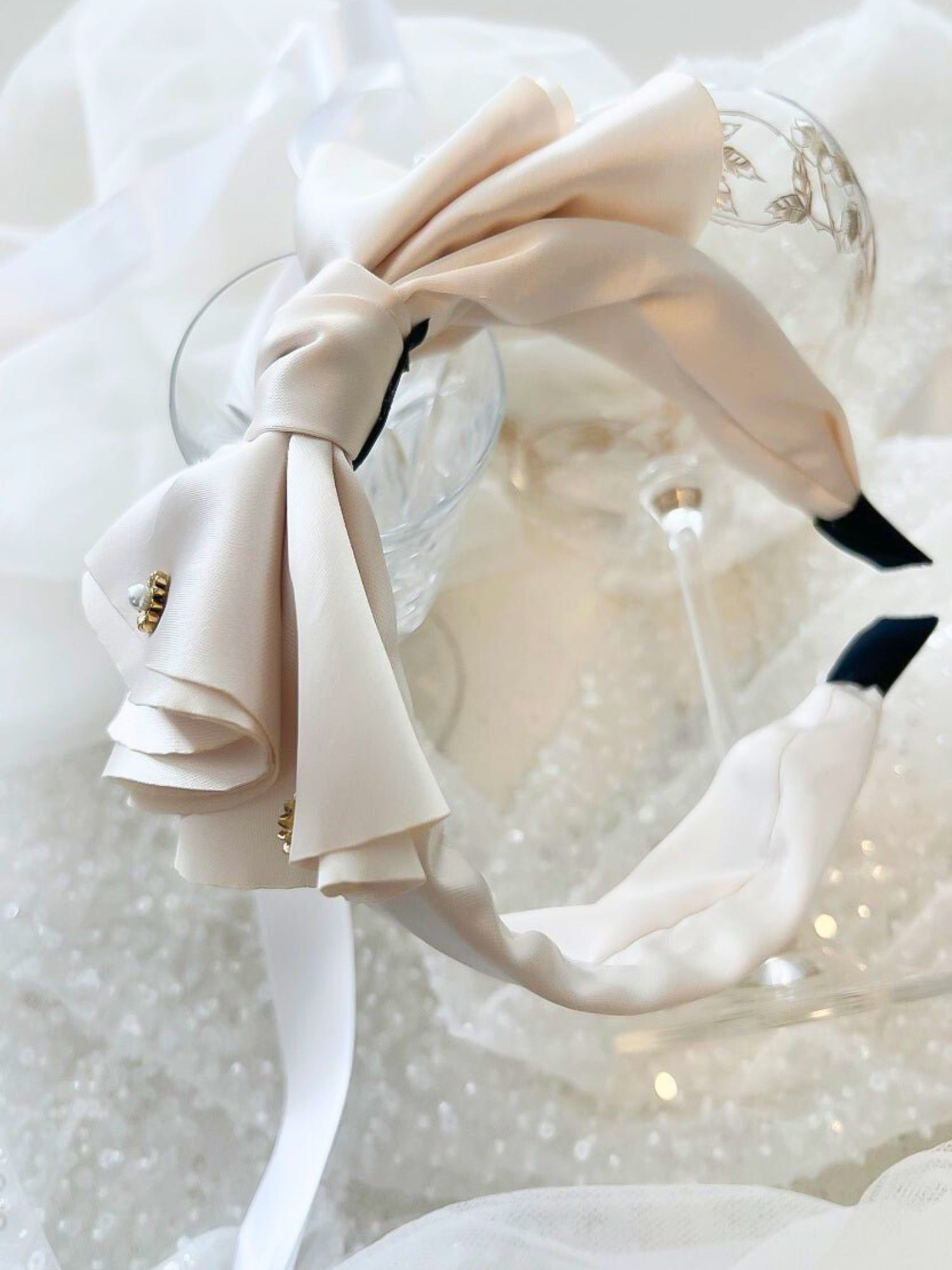 Elegant white bow headband with a large bow and pearl embellishment for special occasions