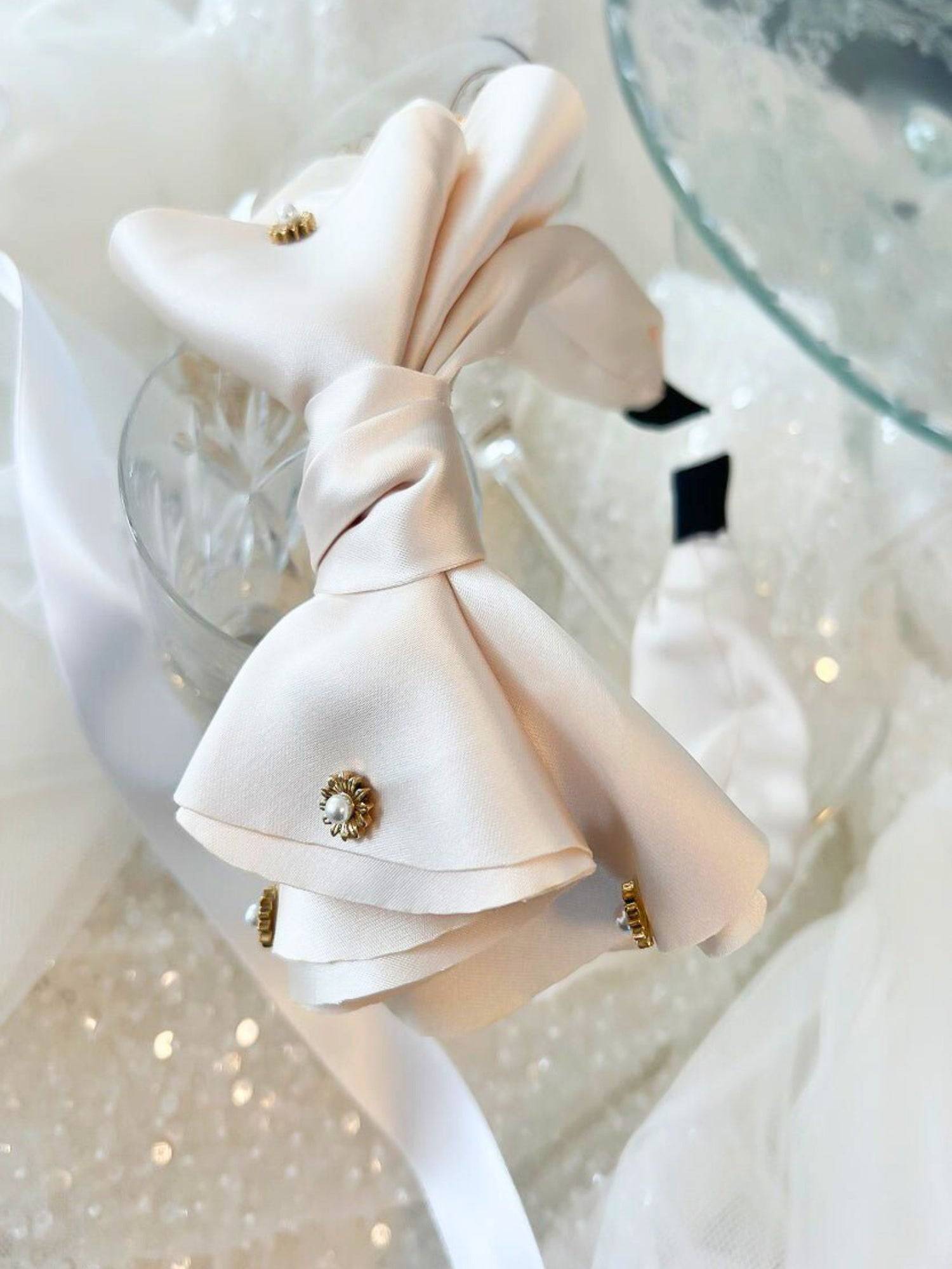 Delicate white bow headband with jewels ideal for a gown or grand bow sash styling.